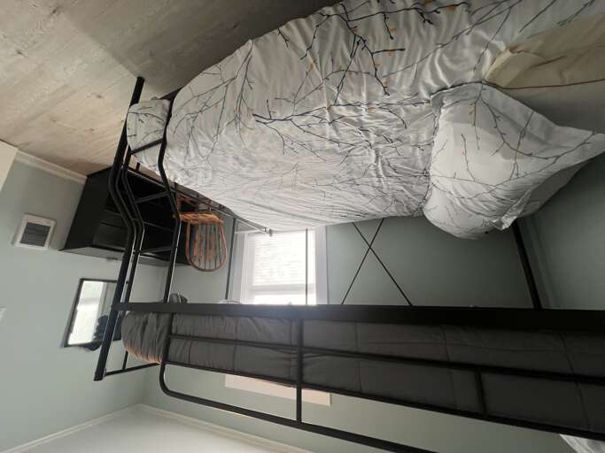 Your cozy retreat features sturdy bunk beds perfect for families or groups. Each bed is thoughtfully designed with soft linens and decorative string lights, creating a warm, inviting space for restful nights.