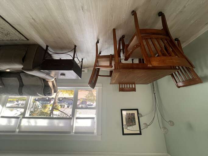 A cozy dining space / game table awaits with a warm wooden table and chairs