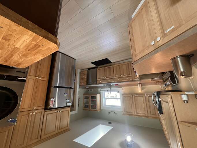 A fully equipped kitchen awaits with modern appliances, warm wood cabinetry, and ample prep space for your culinary adventures during your stay.