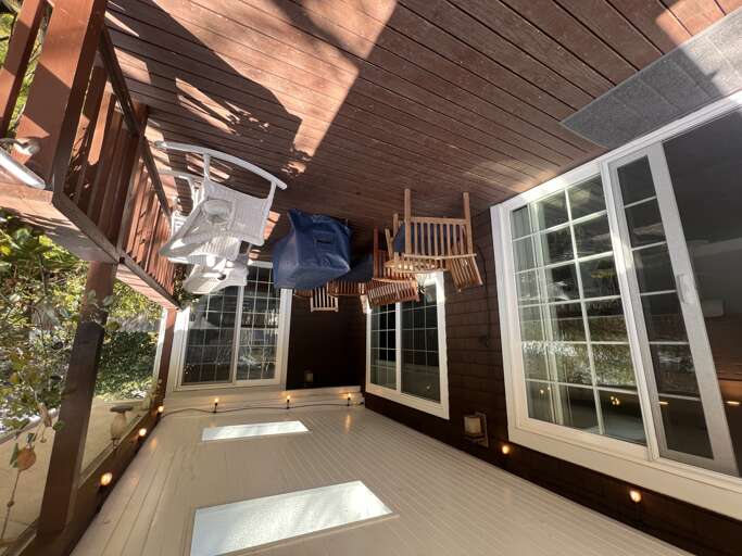 Step onto your private deck where warm wood tones and soft ambient lighting create a peaceful outdoor retreat, perfect for morning coffee or unwinding under dappled sunlight.