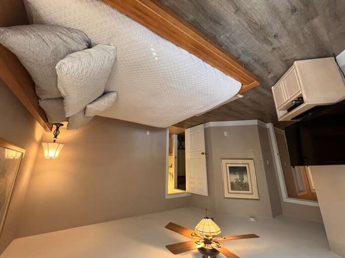 Drift off with soft textured bedding, warm lighting, and a cozy ambiance that makes you feel right at home.