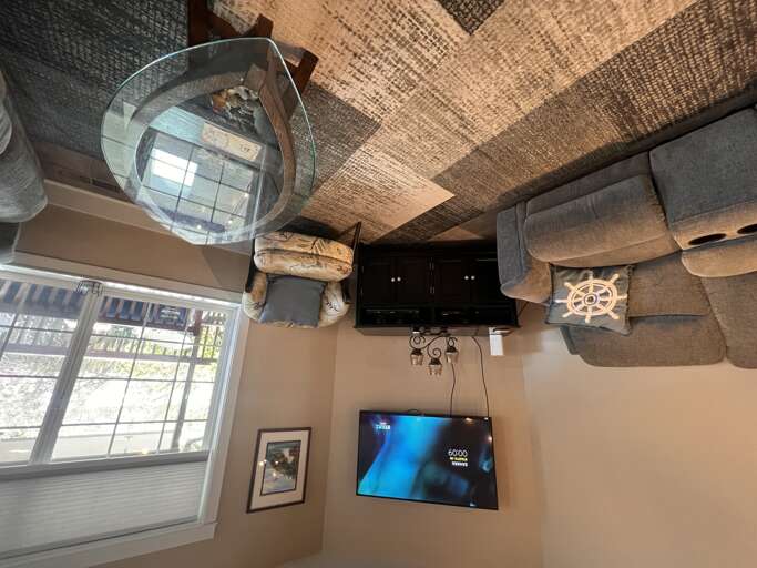 Relax in your cozy living space with plush seating, charming nautical dÃ©cor, and dual entertainment screens for movie nights or catching the game.