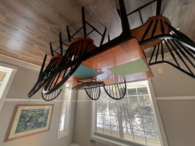This unique storage solution features colorful surfboards mounted overhead, combining your love for adventure with clever space-saving design that keeps your gear organized and ready.