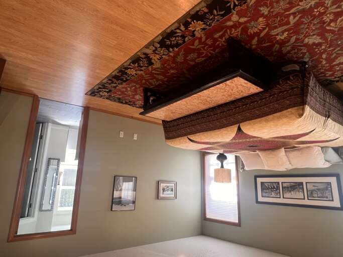 Settle into your uniquely styled retreat, where rich textiles drape overhead and warm wood tones create an inviting, artful ambiance.