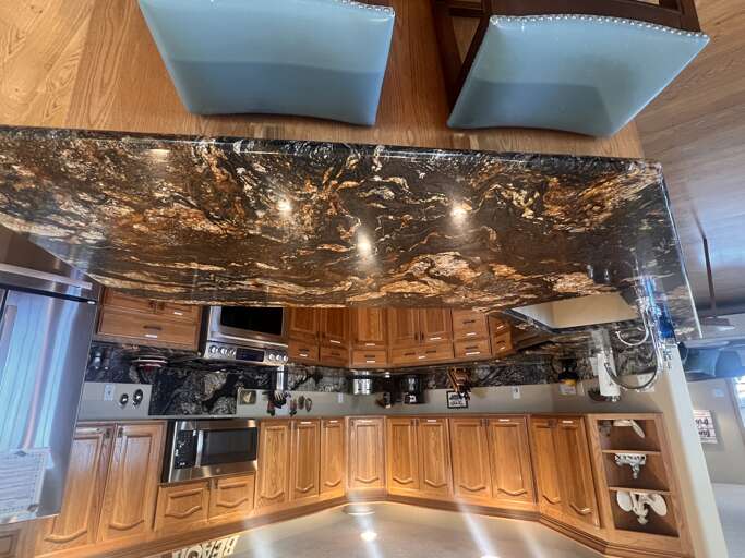 Your gourmet kitchen awaits with stunning granite countertops and top-of-the-line appliances. Rich wood cabinetry and a spacious island make meal prep effortless, while modern conveniences ensure every culinary moment feels luxurious.