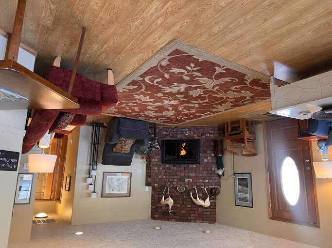 Cozy living room with a charming brick fireplace and rustic wood-beam ceilings creates a warm retreat for your evenings in. Comfortable seating invites you to unwind by the fire.