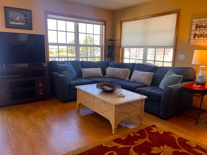 Sink into the plush sectional and enjoy your favorite shows on the flat-screen TV, or simply gaze out at the scenic views through the bright windows. This cozy living room is your perfect retreat.