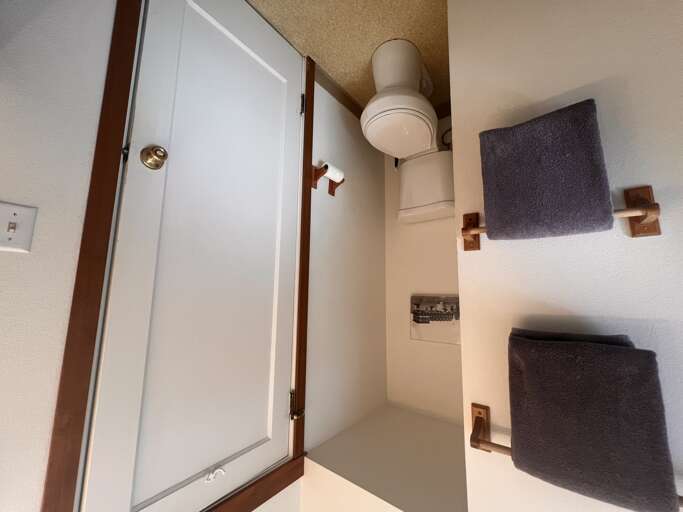 Your private bathroom features modern fixtures and thoughtful storage, with neatly folded towels waiting for your arrival.