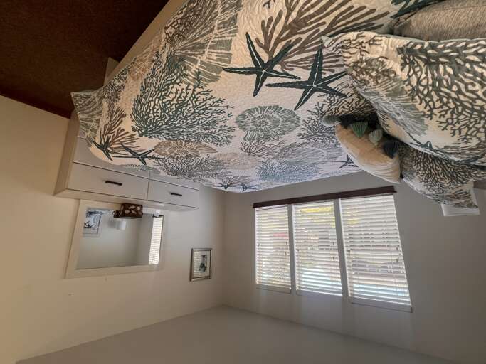 Your private sanctuary features an artistic ocean-themed ceiling mural with coral patterns, creating a unique underwater-inspired retreat.