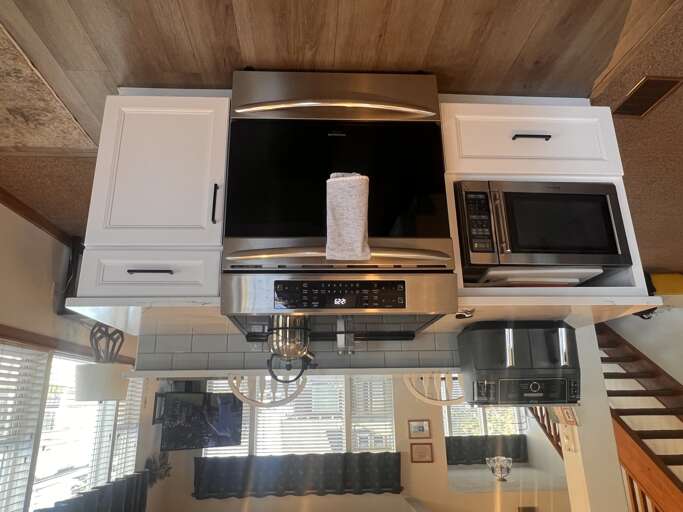 Your modern kitchen features stainless steel appliances and white cabinetry, perfect for preparing memorable meals during your stay.