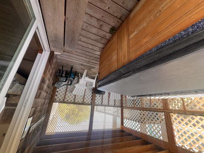 Your private balcony offers warm wood details and lattice railings, creating a cozy outdoor retreat with mountain views.