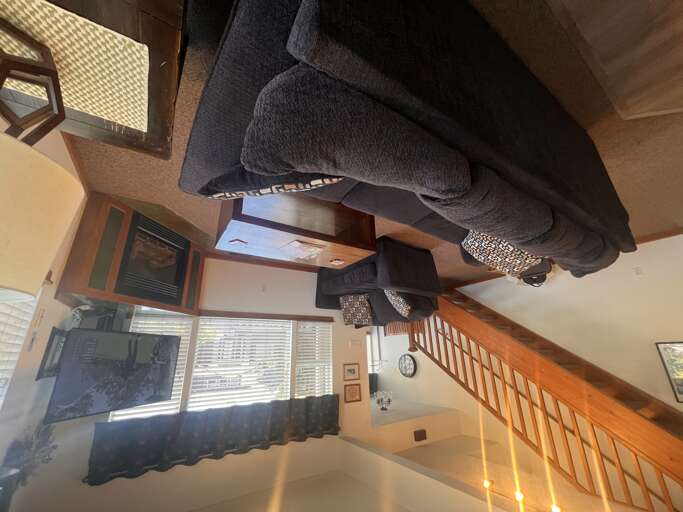 Settle into your cozy living room where soft seating and warm lighting create the perfect spot for relaxation after exploring.