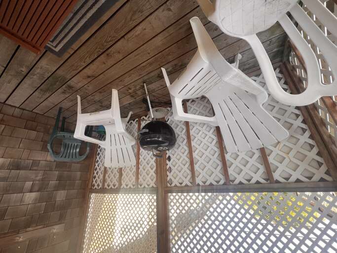 Step onto your private wooden deck where white plastic chairs await your morning coffee or evening relaxation sessions.