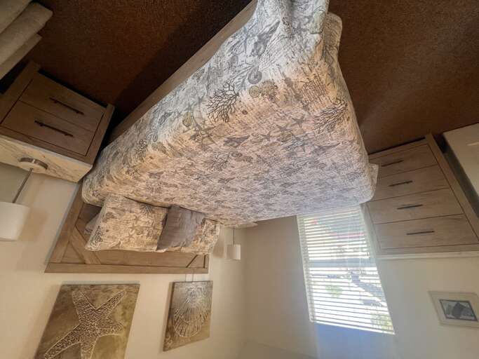 Your unique bedroom features artistic ceiling details and built-in storage, creating a cozy retreat with natural light.