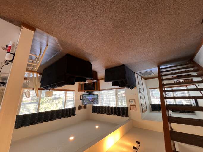 Unwind in your unique loft space with bunk beds, entertainment system, and cozy lighting for memorable nights with friends.