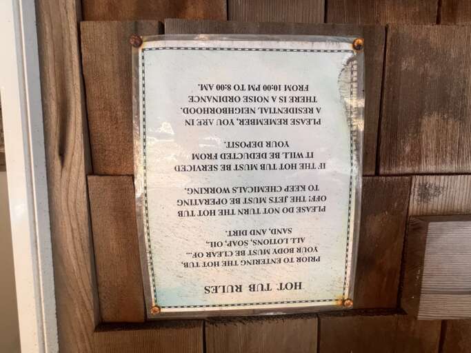 A vintage hot tub rules sign outlines safety guidelines for your relaxing soak sessions.