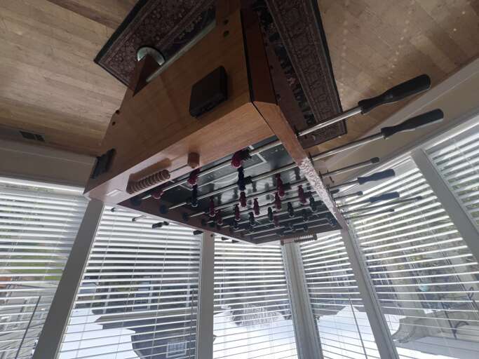 Challenge friends to exciting foosball matches in this bright, window-filled game area where competitive fun meets relaxing atmosphere.