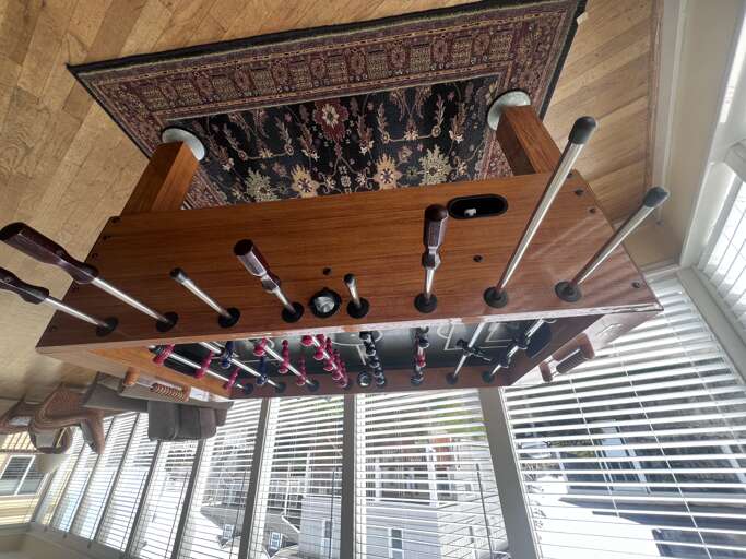 Challenge friends to an exciting game on your vintage foosball table, where classic design meets competitive fun in natural light.