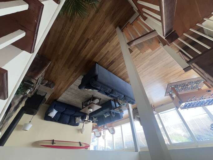 Relax in your bright loft space with exposed beams and cozy seating beneath soaring ceilings.