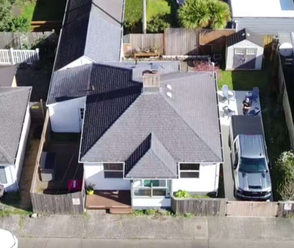 Aerial view of the property showing a well-maintained residential home with parking, private outdoor spaces, and convenient neighborhood access, nestled in a quiet suburban setting.