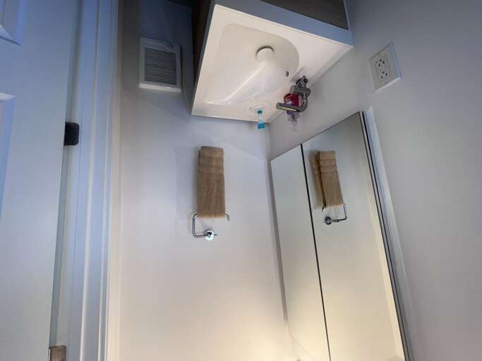 Bright, spotless bathroom with a clean modern sink and fresh towels for your stay.