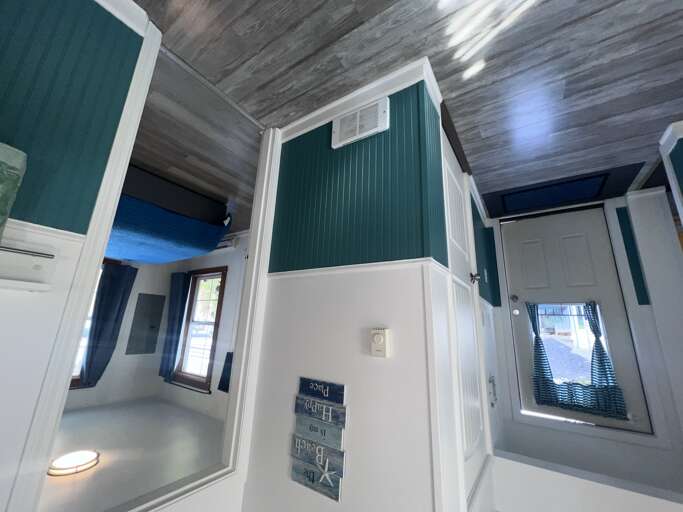 Your cozy retreat features striking teal accents and wood-grain ceilings, creating a welcoming space where rustic charm meets modern comfort.
