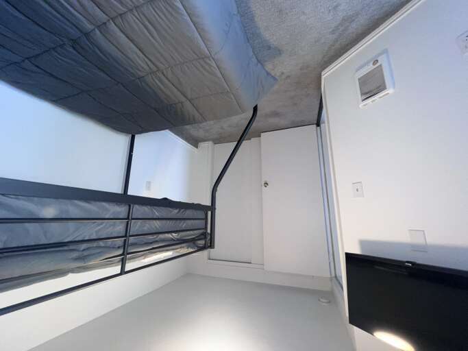 Your cozy sleeping nook features a bunk bed setup with climate control, offering a comfortable retreat after a day of exploring the area.