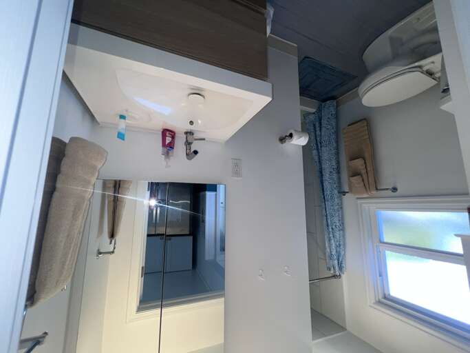 Your private bathroom features a modern sink, fresh towels, and a spacious walk-in showerâeverything you need to refresh after a day of exploring.