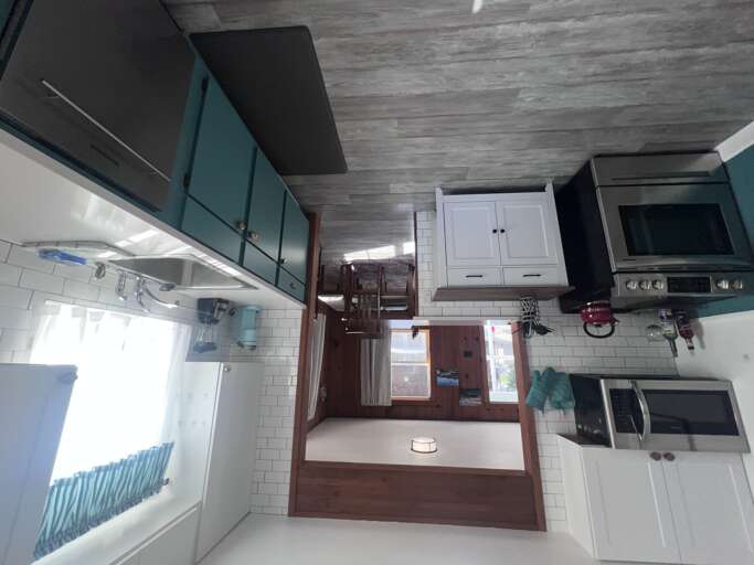 Your stylish kitchen blends coastal vibes with modern convenienceâsleek cabinetry, stainless appliances, and a serene color palette make meal prep a pleasure.