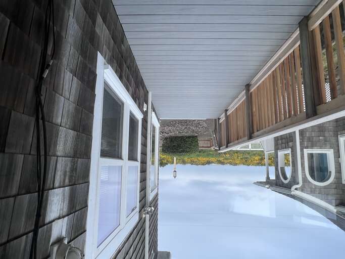 The property features a covered breezeway connecting different sections of the building, creating a sheltered outdoor pathway for easy access between spaces.
