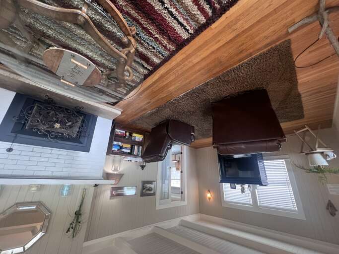 Settle into plush leather seating in your private living space, where warm wood tones and thoughtful touches create an inviting retreat after your day's adventures.