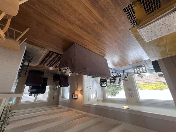 Step into your bright and inviting living space where warm wood tones meet coastal charm. Relax on the plush sectional and let natural light stream through large windows as you settle in for your getaway.