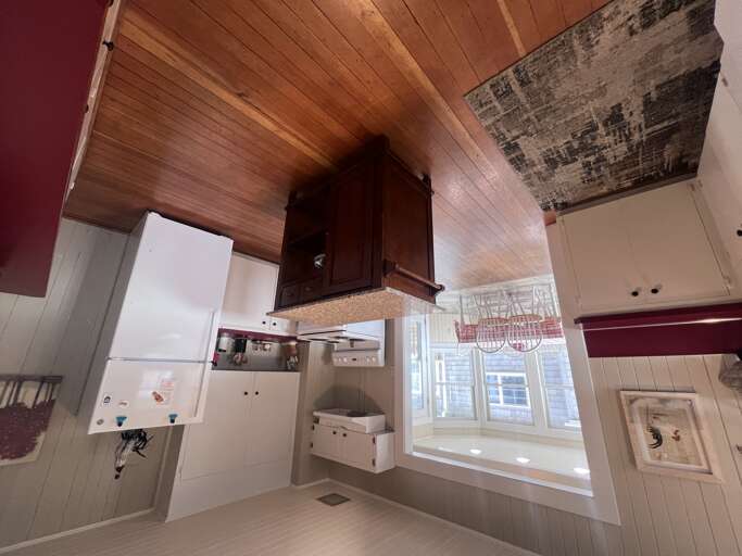 Step into your charming kitchen, antique cabinetry, and a cozy window seat that invites you to relax with morning coffee.