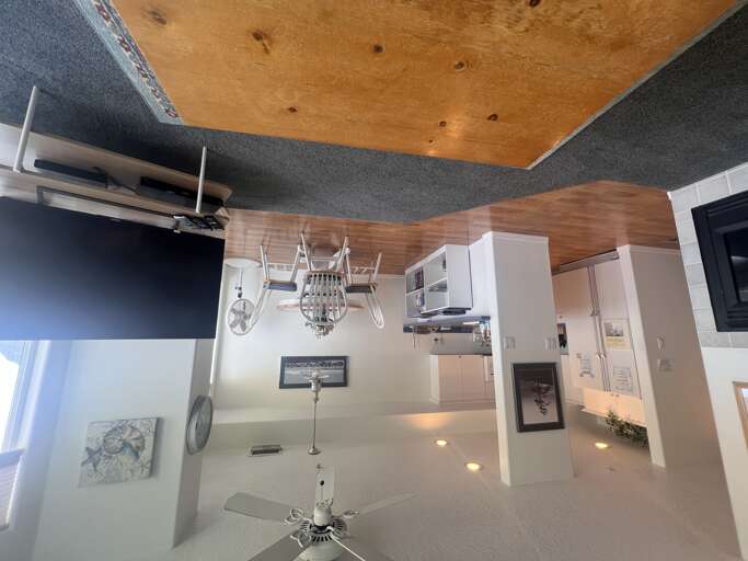 Unique rustic ceiling meets sleek modern kitchen with white cabinetry and granite countersâyour space to create memorable meals in style.