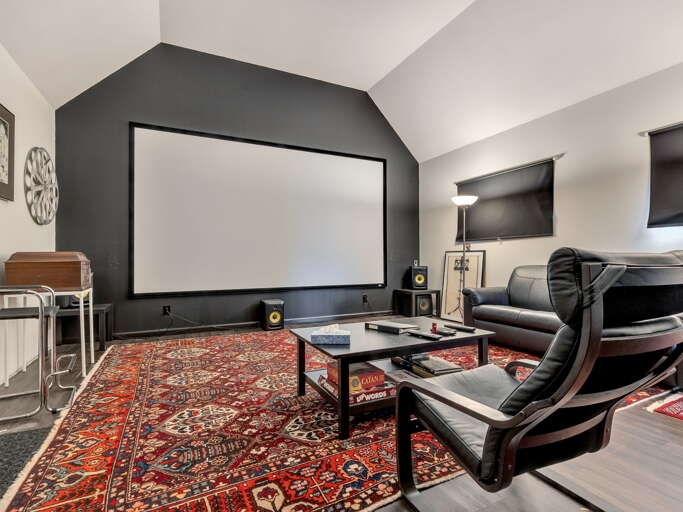 Settle into plush seating and enjoy your favorite films on the impressive projector screen. This cozy entertainment space offers high-quality sound, comfortable chairs, and a perfect movie-night atmosphere.