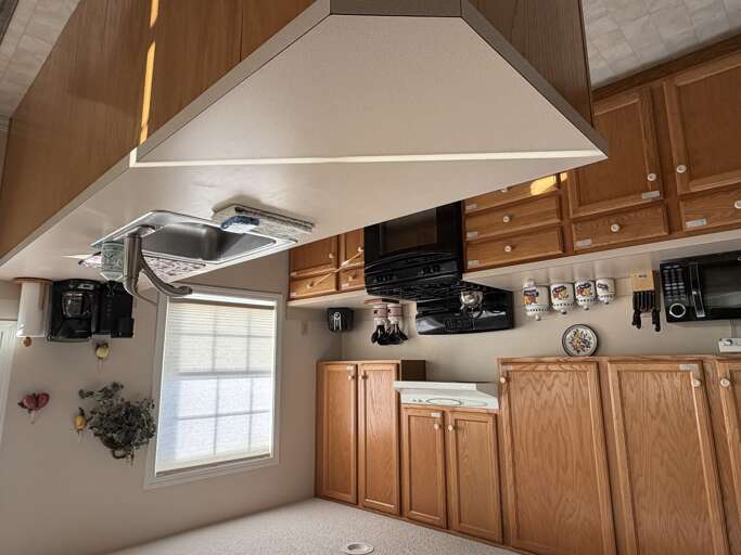 A fully equipped kitchen awaits you, featuring warm wood cabinetry, modern appliances, and everything you need to prepare your favorite meals during your stay.