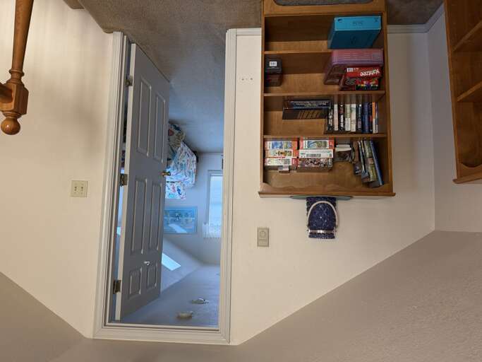 Unwind in your cozy hallway retreat with thoughtful touches like board games and books waiting for your leisure time.