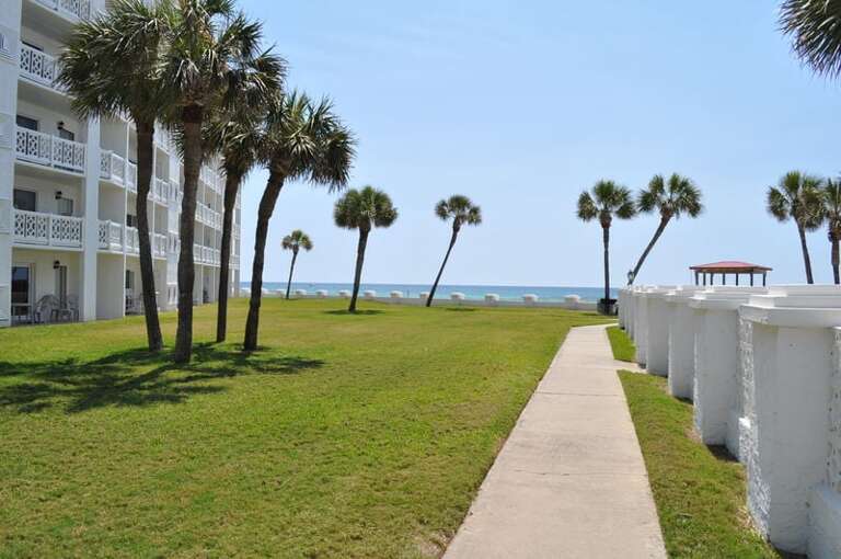 Ground Level patio (left) near beach and pool (right) - El Matador Resort, Okaloosa Island Fort Walton Beach Vacation Rentals