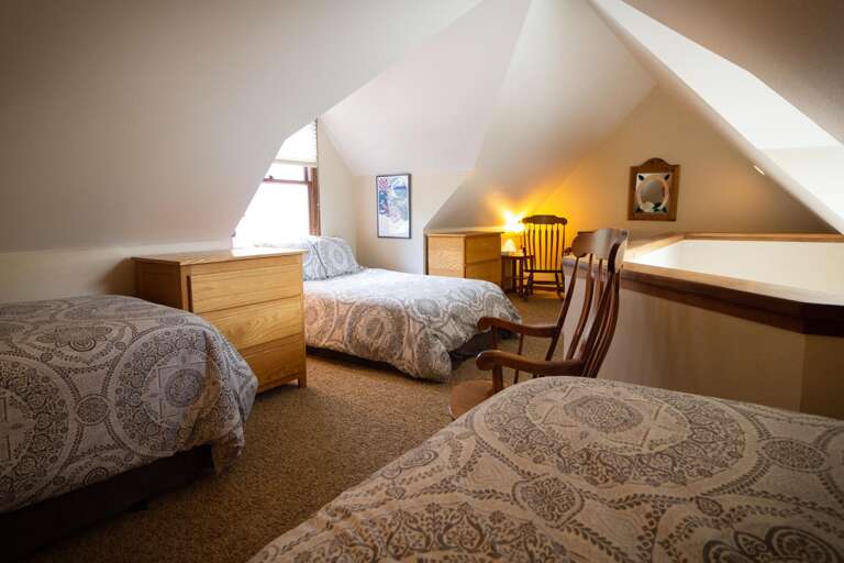 Bedroom with 3 beds and a nightstand