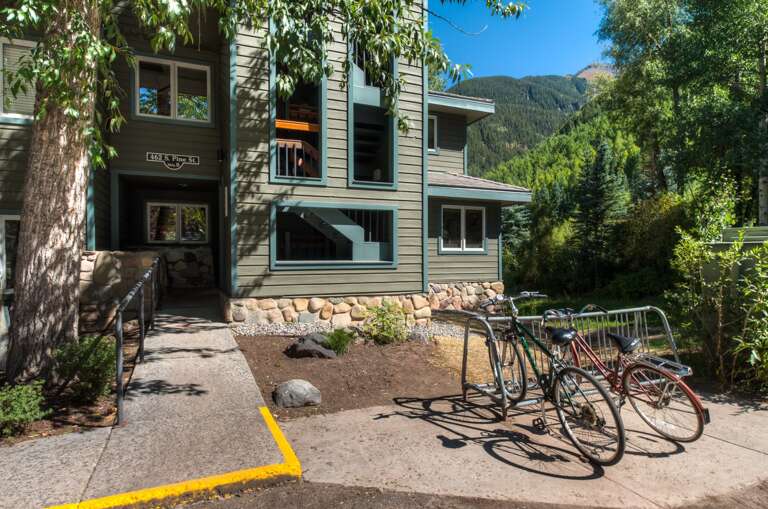 Front Exterior of green sided building with bike rack