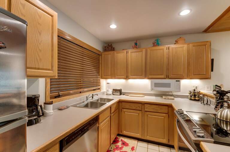 Kitchen with wood cabinets and light countertops Kitchen with wood cabinets and light countertops
