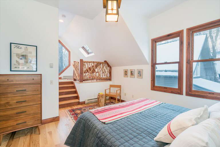 Bedroom with Reading Nook, Large Bed, and Drawer Dresser