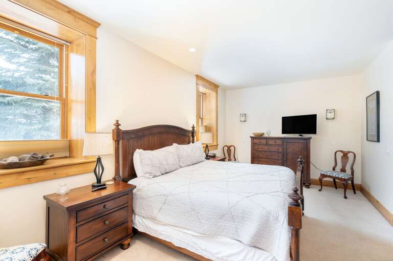 Master bedroom with dresser and HD TV