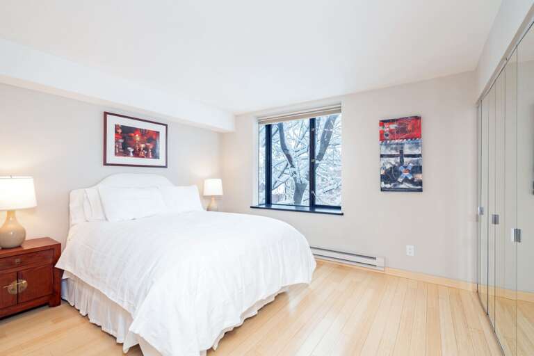 Bedroom with wall-length mirrors.