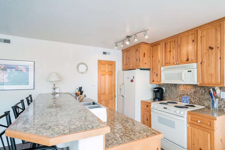 Full Kitchen with Wooden Cabinetry at Outlaws #7A