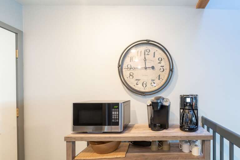 A microwave, a coffee machine and a clock