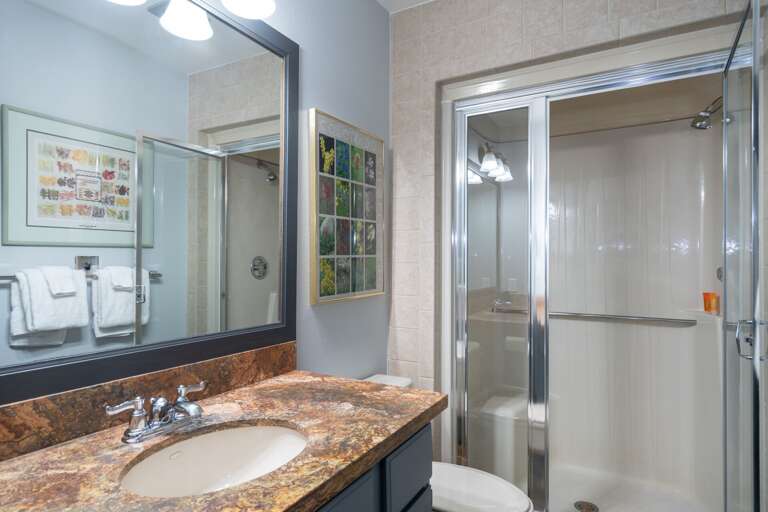 A walk shower and a sink