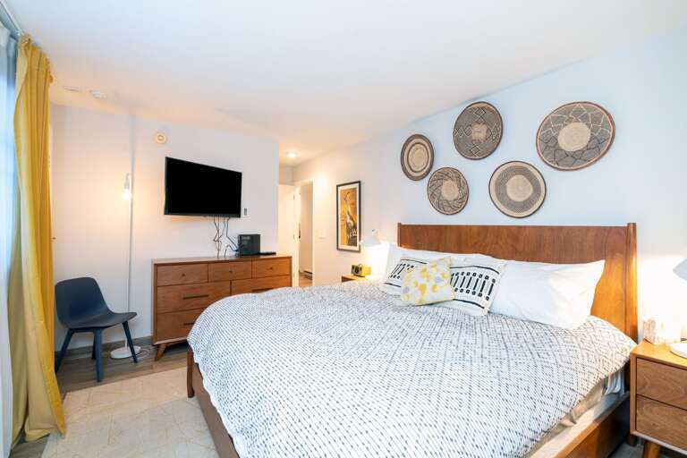 Bedroom with a queen-size bed and a flat-screen tv
