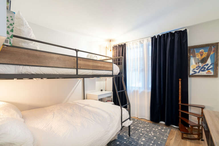 Two bunkbeds and black curtains
