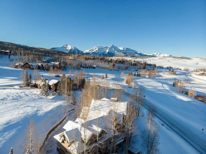 Aerial view of this Telluride golf rental and the surrounding area covered in snow. Aerial view of this Telluride golf rental and the surrounding area covered in snow.